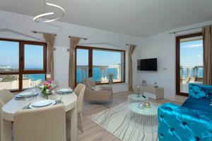 a living room with a blue couch and a table at La Mer Penthouse in Varna City