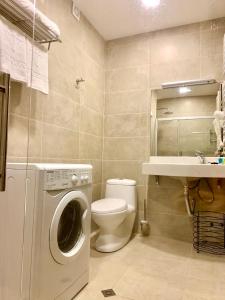 a bathroom with a washing machine and a toilet at Crystal Resort B304 LUX in Bakuriani