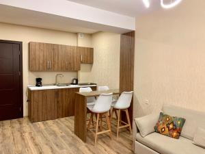 a kitchen and living room with a couch and a table at Crystal Resort B304 LUX in Bakuriani