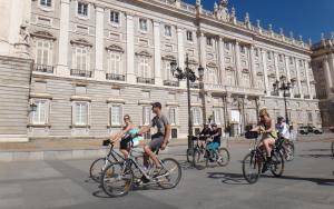 a group of people riding bikes in front of a building at Lagasca Charming Apartment in Madrid