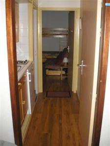 a hallway of a room with a kitchen and a sink at clos des gentianes in Allevard