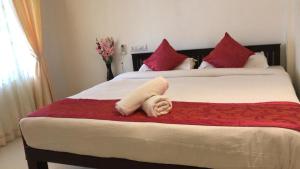 a stuffed animal is laying on a bed at SUN VIEW Beach Resort By Citrine in Varkala