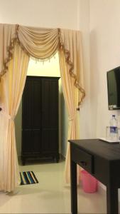 a room with a window with a desk and a television at SUN VIEW Beach Resort By Citrine in Varkala