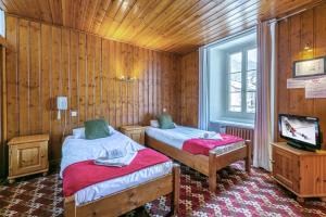 מיטה או מיטות בחדר ב-Hotel Le Chamonix