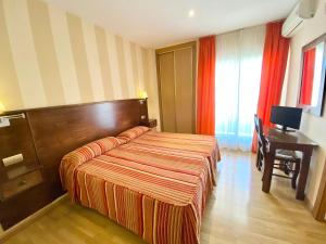 Posteľ alebo postele v izbe v ubytovaní Hotel Fernando IV