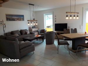 a living room with a couch and a table at Haus Am Peenestrom in Peenemünde