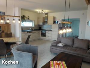 a living room with a couch and a table at Haus Am Peenestrom in Peenemünde