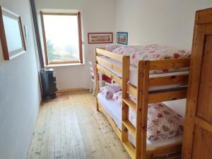 a bedroom with two bunk beds and a window at CASA IDA - ClPAT 22253 in Tregiovo
