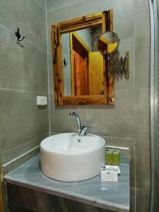 a bathroom with a sink and a mirror at Infinity Lodge in Wadi Musa