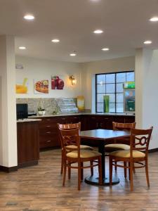 a dining room with a table and chairs and a counter at Quality Inn & Suites in Prestonsburg