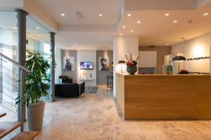 a lobby with a reception desk in a building at Hotel Dimorae in Civitanova Marche