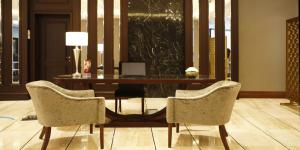 a desk with two chairs and a table with a laptop at Crowne Plaza Istanbul Oryapark by IHG in Istanbul