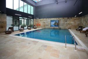 a large swimming pool in a large building at Crowne Plaza Istanbul Oryapark by IHG in Istanbul