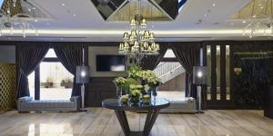 a lobby with a table with flowers and a chandelier at Crowne Plaza Istanbul Oryapark by IHG in Istanbul
