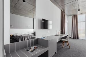 a hotel room with a desk and a bed at WELCOME summer in Zatoka