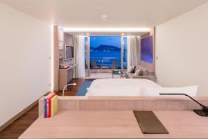 a bedroom with a bed and a view of the ocean at Oceanfront Beach Resort - SHA Extra Plus in Patong Beach