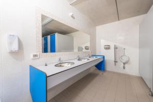 a bathroom with two sinks and a mirror at Agricampeggio Relax (Campsite) in Brenzone sul Garda