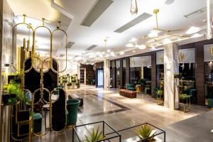 a lobby with chairs and plants in a building at Sevsamora Resort & Spa in Saguramo