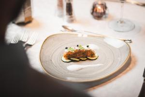 a plate of food on a table with fork and knife at Alpine Resort Goies Superior in Ladis +136 photos