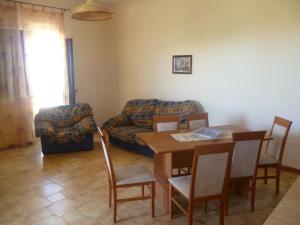 a living room with a table and a couch at LA FINESTRA SUL MARE in Trappeto