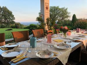a table with plates and utensils on top at B&B Romy Rocker in Verona