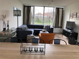 a living room with a couch and a table at ESCARGOT in Middelkerke