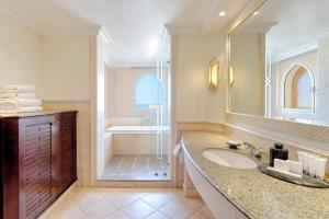 a bathroom with a sink and a large mirror at Kempinski Hotel Soma Bay in Hurghada