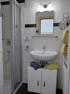 a bathroom with a sink and a mirror at Apart Almrausch in Nauders +23 photos