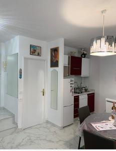 a kitchen with a white door and a table at Cannes 3 min from Congress Palace, Croisette, Beaches in Cannes