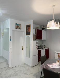a kitchen with a white door and a table at Cannes Apartment close to Congress Palace, Croisette, Beaches in Cannes +40 photos