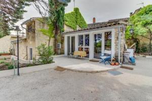 a house with a large patio with at Provence Dream Chalet in Uchaux