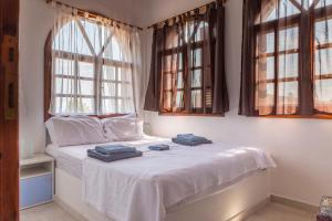 a bedroom with a bed with two towels on it at Cielle Epoque in Pefkohori +28 photos