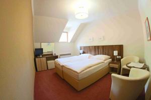 Voodi või voodid majutusasutuse Hotel Koruna toas