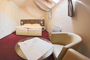 Voodi või voodid majutusasutuse Hotel Koruna toas