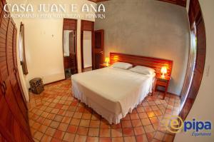 Giường trong phòng chung tại Pipa Casa Juan e Ana +15 ảnh