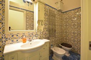 a bathroom with a sink and a toilet at Luxury Apartment Amalfi in Amalfi