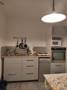 a kitchen with a sink and a stove at Topaze in Monnières