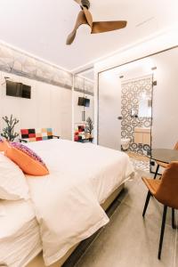 a bedroom with a large bed and a ceiling fan at King's Rooftop Studios in Tel Aviv