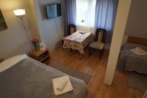 a room with two beds and a table and a window at Dom Gościnny 8 km od Suntago, Deepspot in Radziejowice