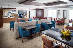 un restaurante con sillas y mesas azules en una habitación en Holiday Inn Express Hotel & Suites Bellevue-Omaha Area, an IHG Hotel en Bellevue