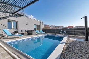 a swimming pool in the backyard of a house at Apartment Lotte with private pool in the city center! in Makarska