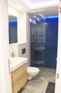 a bathroom with a toilet and a sink and a shower at TiTo in Belgrade