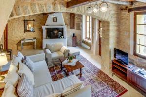 a living room with a white couch and a fireplace at Provence Dream Chalet in Uchaux