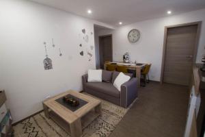 a living room with a couch and a table at Chez Emilie & Charles Classé 4 étoiles in Hunawihr