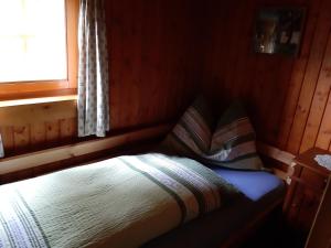 A bed or beds in a room at Platzerhütte