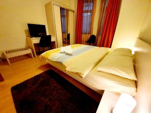 a bedroom with a large bed and a desk at GrandVille Apartments in Bucharest
