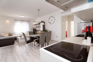 a kitchen and living room with a table and chairs at Vila Ivana Dolores in Vinišće +43 photos