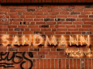 a brick wall with graffiti on it at Sandmann Boutique Hostel Hotel in Hamburg