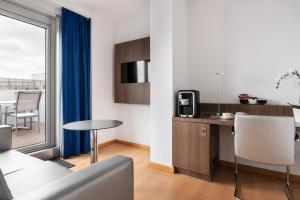 
a living room with a kitchen and a dining room at Eurostars Blue Coruña in A Coruña
