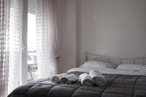 a bedroom with a bed with towels on it at Egnatia Flat in Thessaloniki